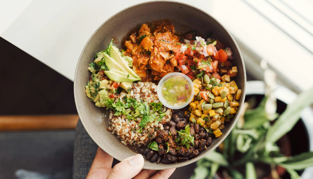 Healthy fish options extended to a vibrant burrito bowl with spiced protein, black beans, quinoa rice, guacamole, pico de gallo, roasted corn, and green dressing