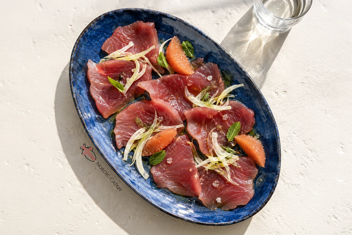 Ahi Tuna crudo style on a blue plate