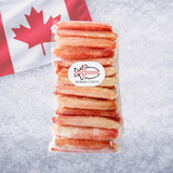 Frozen crab leg segments stacked in clear package with Nordic Catch branding on crushed ice background with Canadian flag