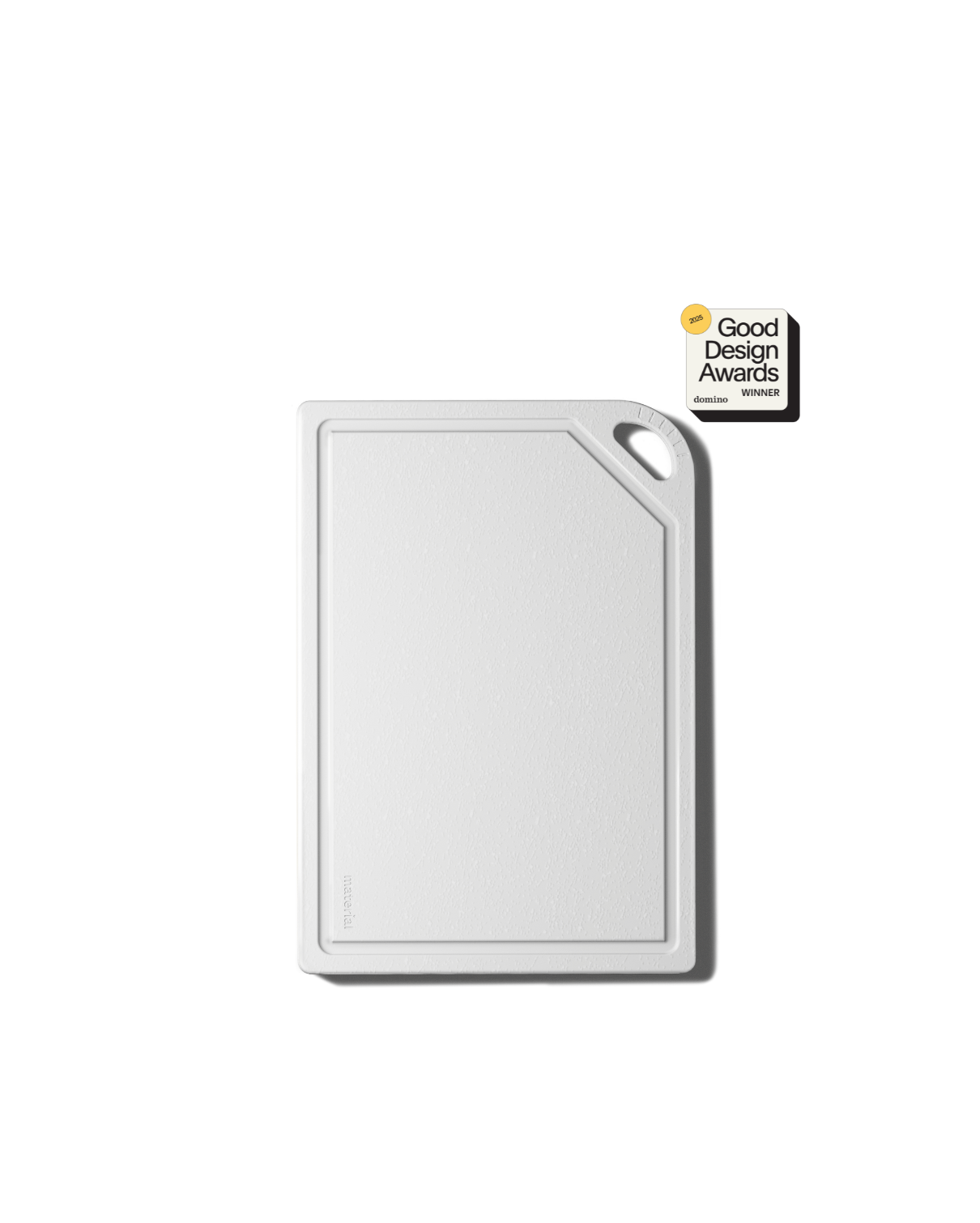 White cutting board with juice groove and black handle displaying Good Design Awards winner certification badge on black background