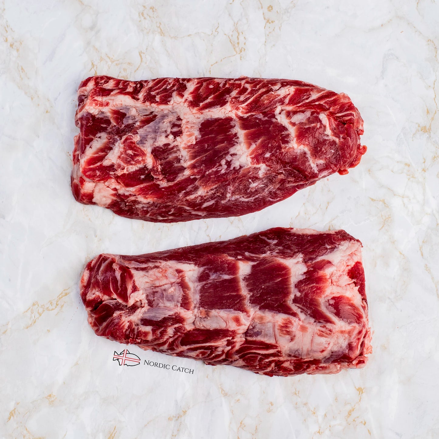 Two raw marbled Iberico pluma cuts, arranged vertically on a white marble surface with a small 'NORIC CATCH' logo near the bottom.