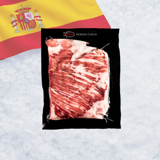 A vacuum-sealed package of Iberico secreto steak, shown on a light textured background with a Spanish flag in the upper left. The package is branded Nordic Catch.