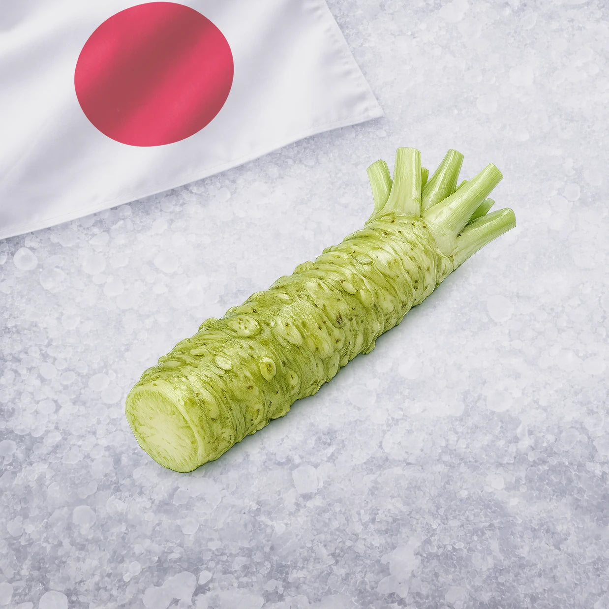 Green wasabi on a gray surface with a Japanese flag in the background