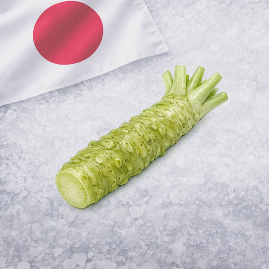 Green wasabi on a gray surface with a Japanese flag in the background