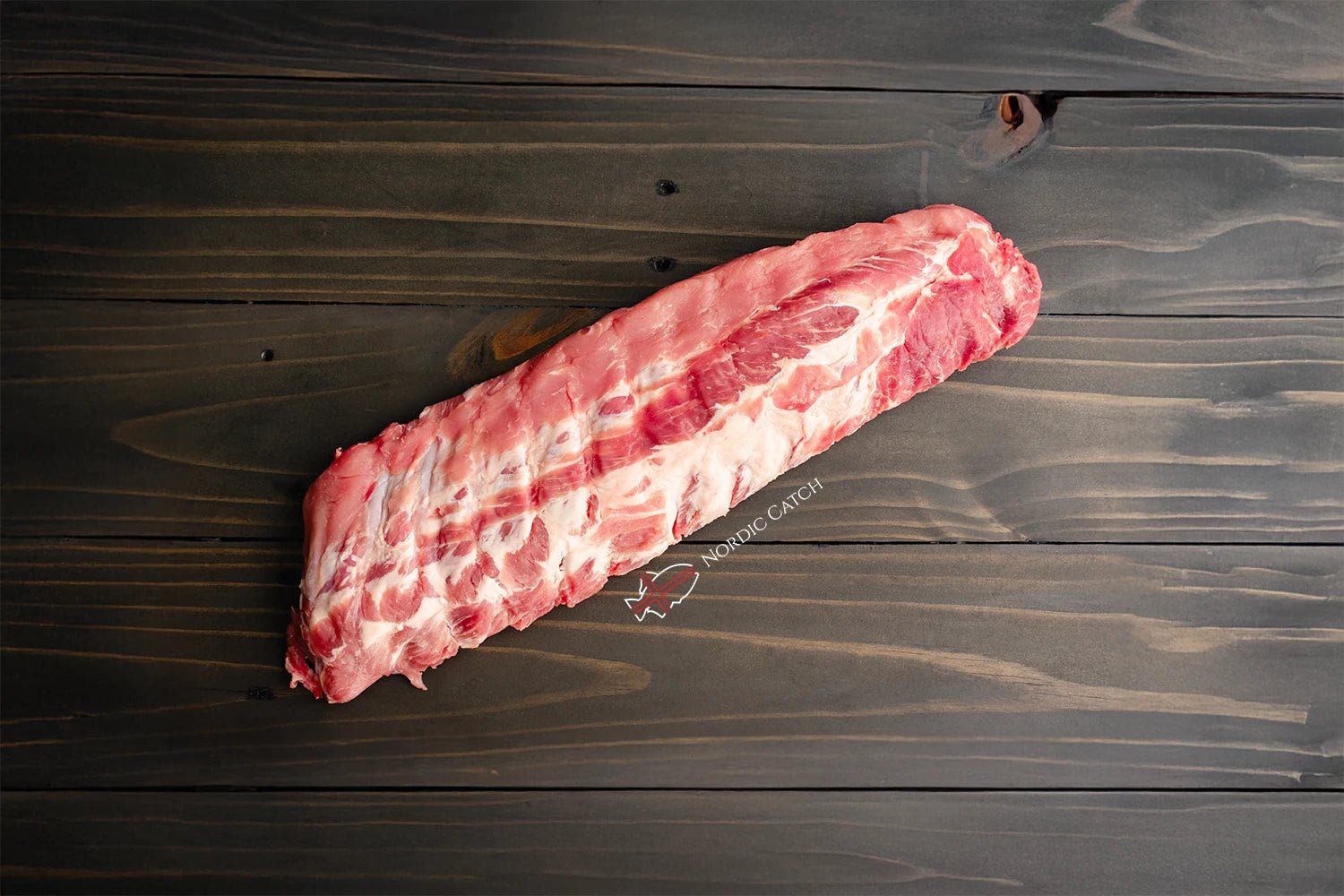 Raw pork ribs on a wooden surface