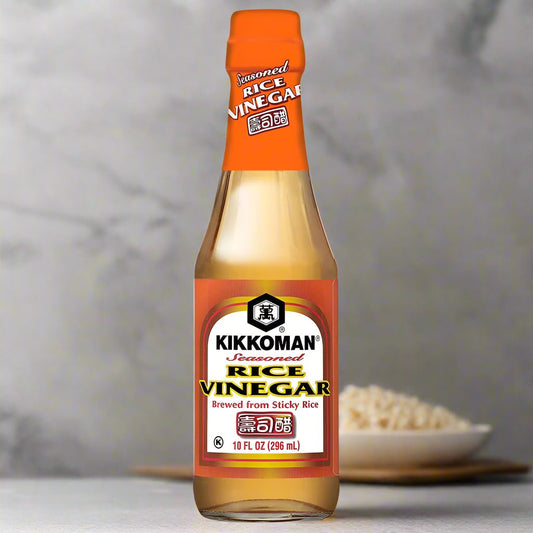 Bottle of Kikkoman seasoned rice vinegar on a white background